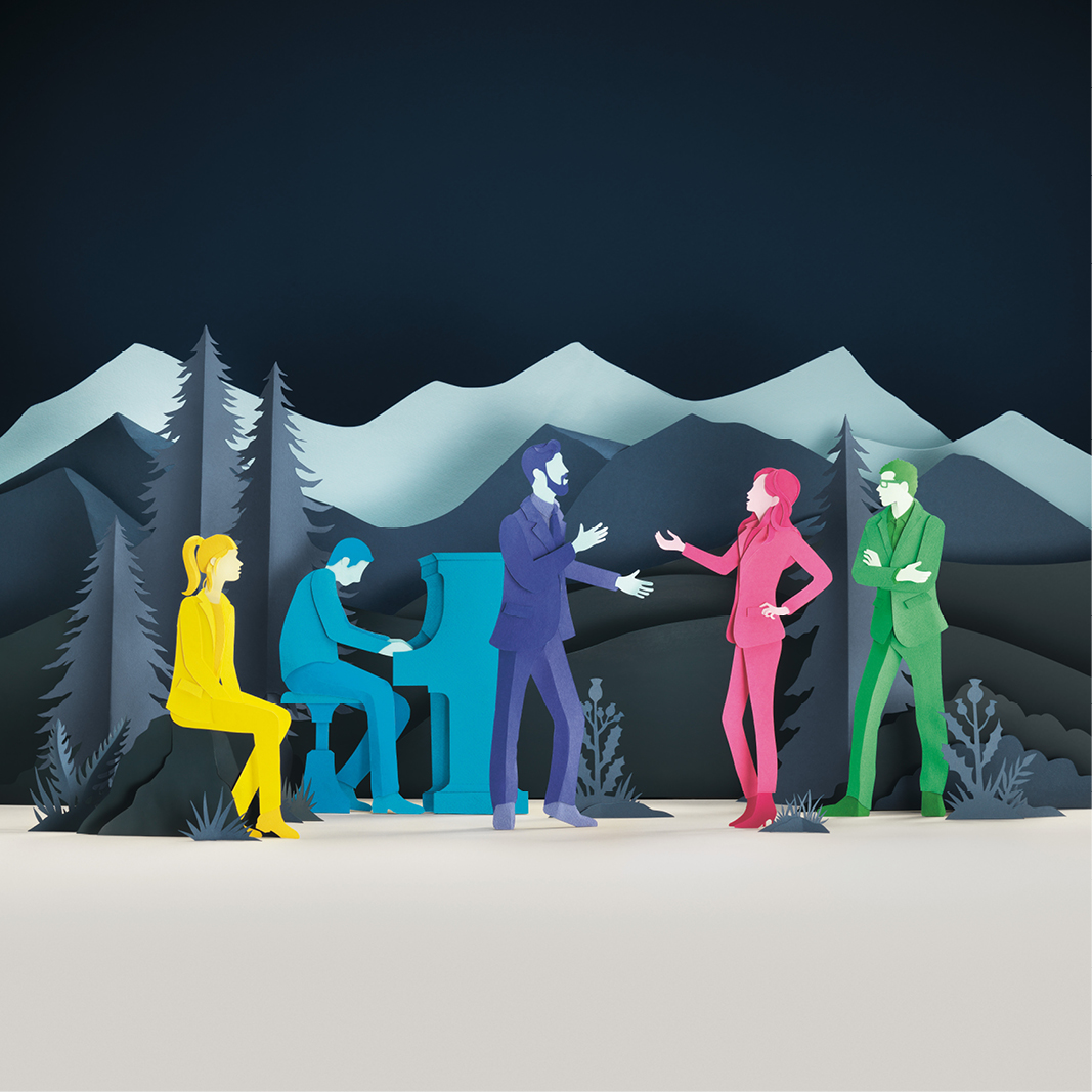 A campaign image featuring four singers and a pianist made of paper sculpture standing in a Scottish landscape. The image was made to promote the touring show, Opera Highights, delivered by Scottish Opera.