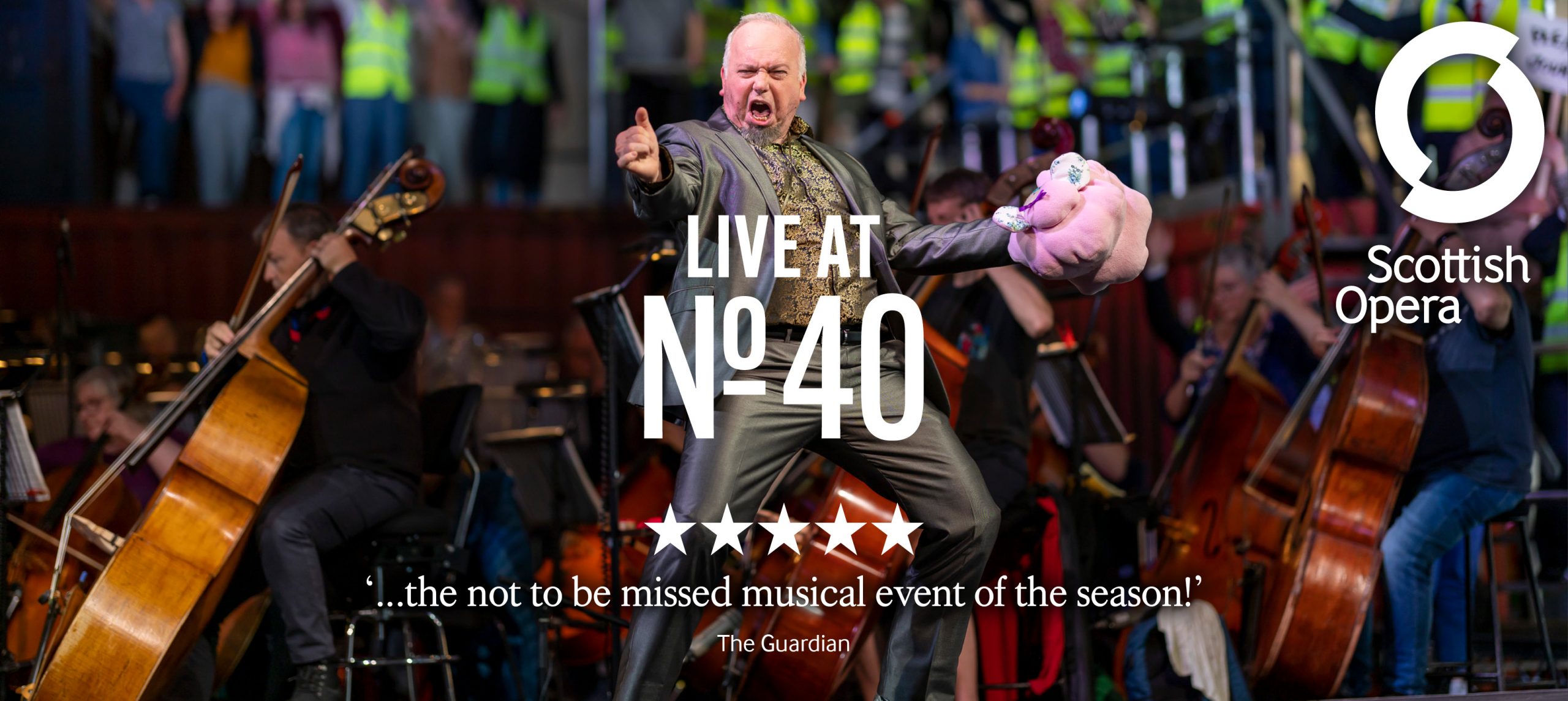 A man singing and dancing on the stage at the Live at No.40 event with a five star review from The Guardian.