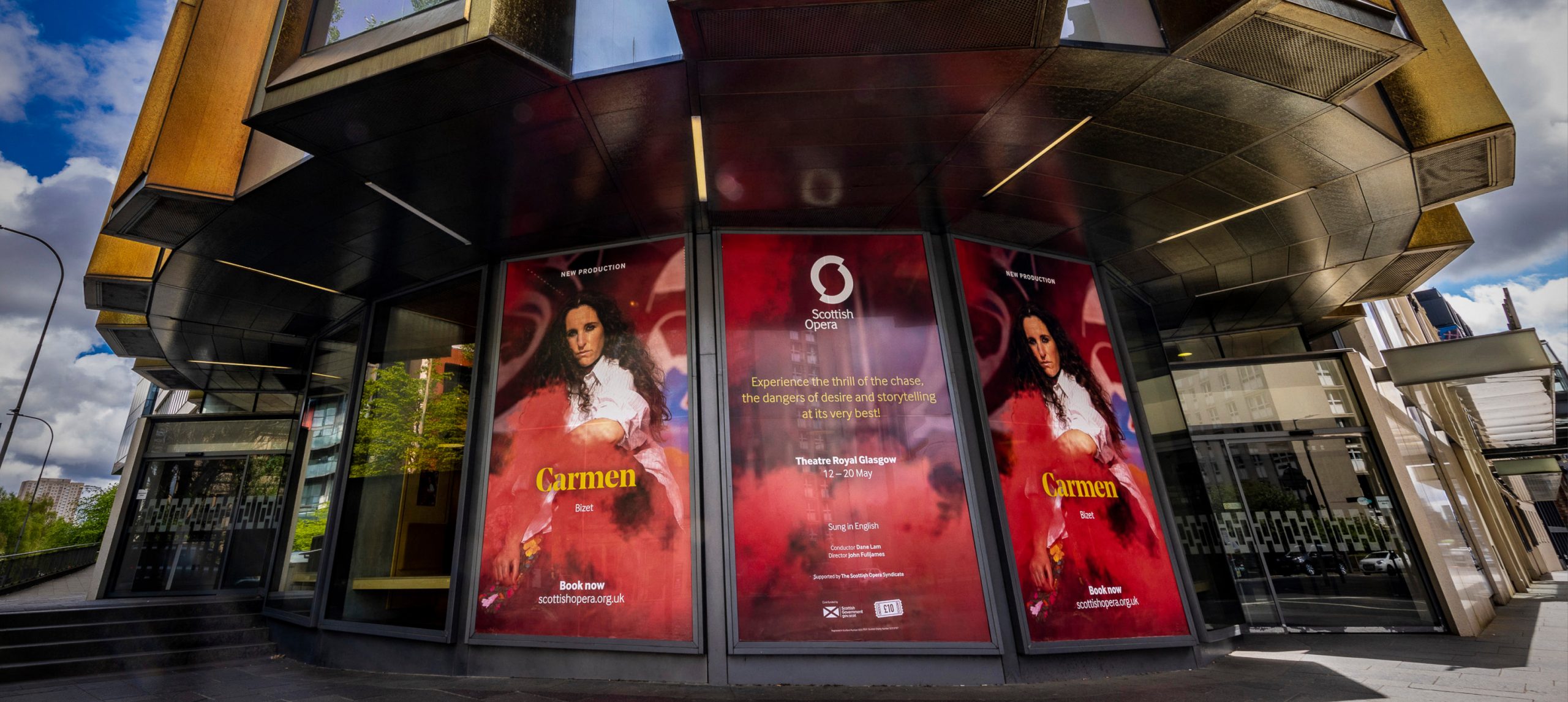 Campaign artwork for an opera called 'Carmen' installed on the outside windows of the Theatre Royal Glasgow.